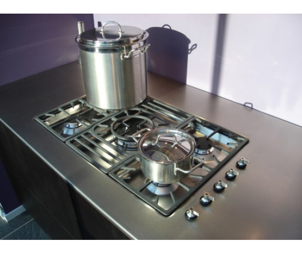 De GKIC95-3 inbouw kookplaat van SMEG geintegreerd in een roestvrijstaal aanrechtblad.