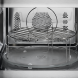 AEG OS5CM34MB inbouw magnetron combi close-up deurklink en aangrenzend bedieningspaneel met draaiknop en functietoetsen in keukensituatie