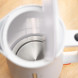 Bosch TWK3M121 waterkoker geopend, interieur toont roestvrijstalen verwarmingselement en witplastiche binnenkant