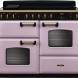 Falcon Classic Deluxe 2026 110 inductie fornuis vooraanzicht in roze met zwart bedieningspaneel en twee ovens