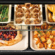 Falcon Classic FX 90 fornuis geopende oven met twee rekken en voedsel in bakplaten