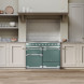 Falcon ELS110DFSS dubbele range cooker ingebouwd in groene keuken met witte kasten en tegels
