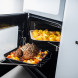 Falcon Estel Deluxe 90 Gas fornuis, geopende onderoven met geroosterd vlees en groenten