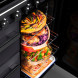 Falcon Estel Deluxe 100 Gas fornuis geopende oven met meerdere laden en gerechten