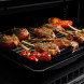 Falcon Infusion 90 Inductie 2026 fornuis, open oven met gegrilde kippenpoten op rooster
