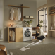 Miele WEG888 WCS in houten meubel met vrouw die de deur opent in moderne wasruimte